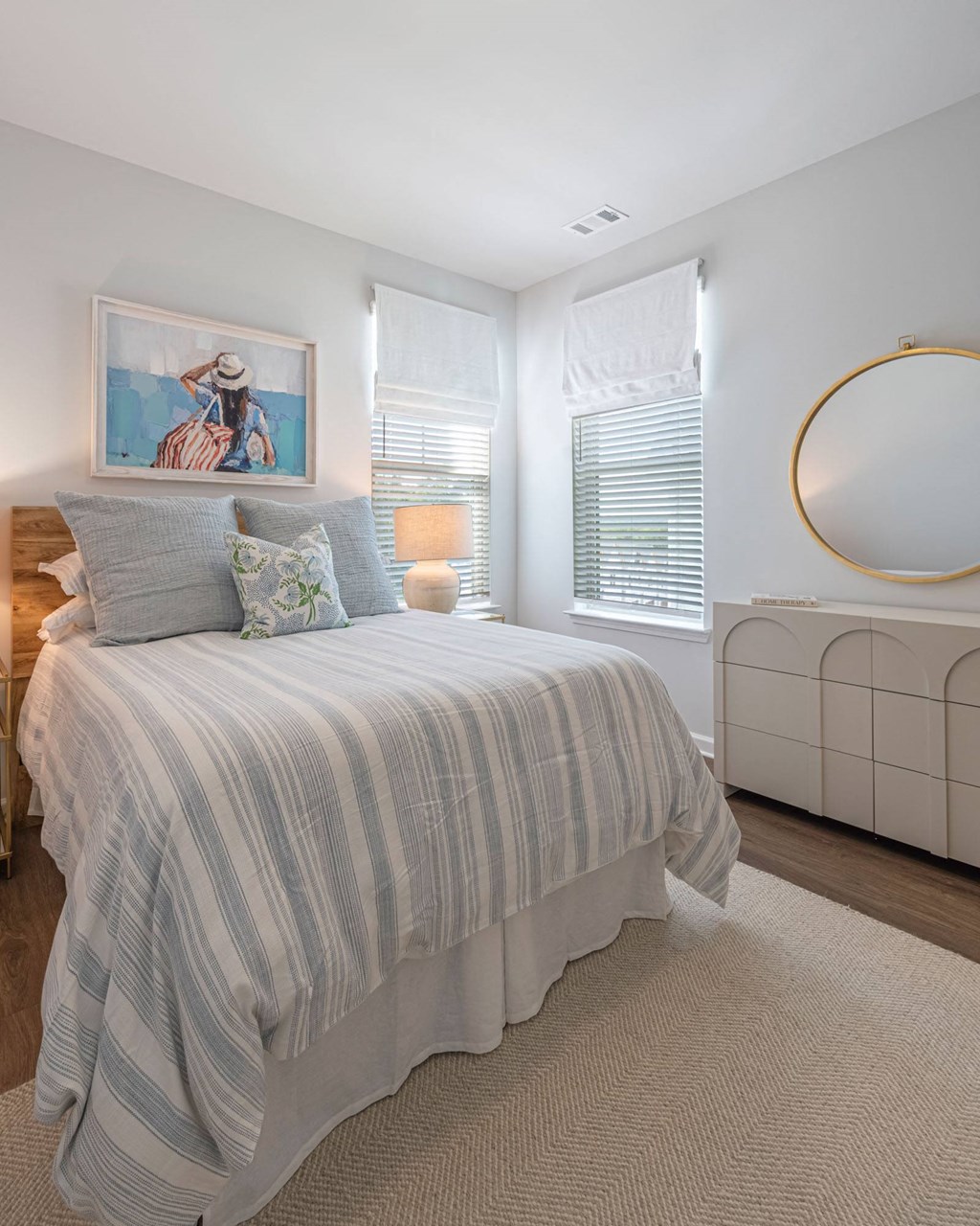 a bedroom with a bed and a mirror