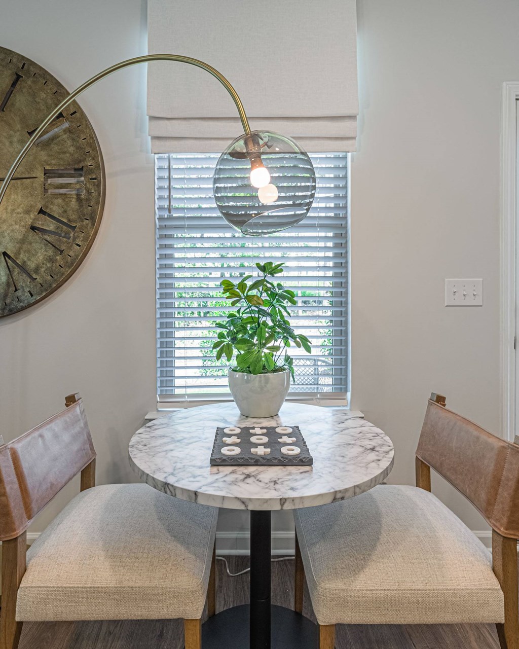 a dining room with a table and chairs and a window