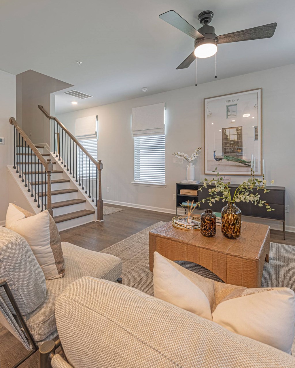 a living room with a couch and a staircase
