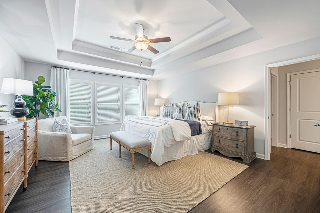 a bedroom with a bed and a ceiling fan