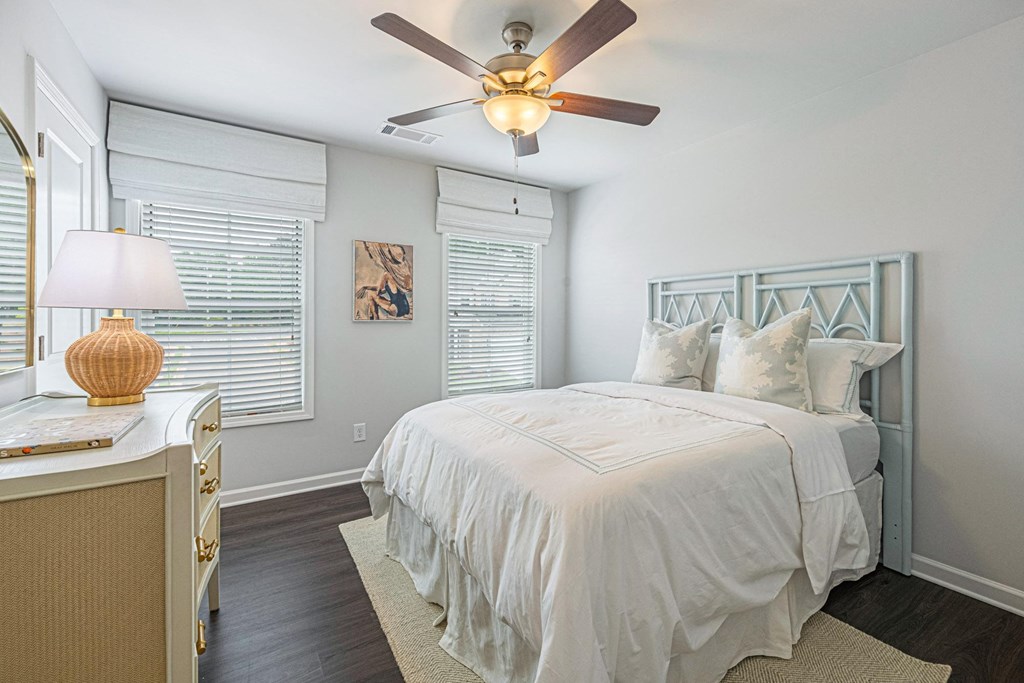 a bedroom with a bed and a ceiling fan