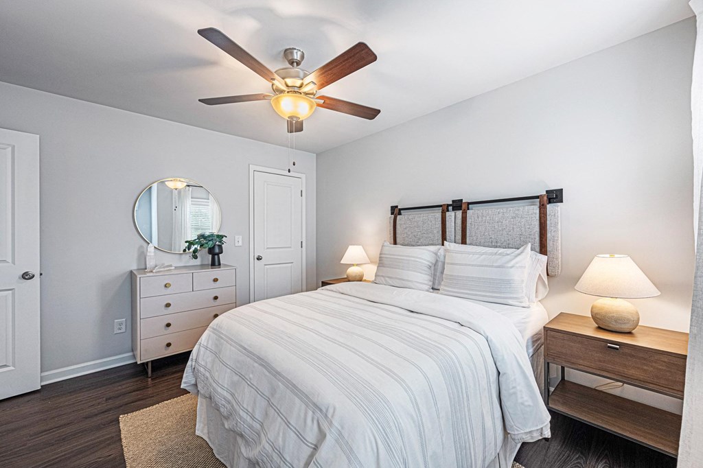 a bedroom with a large bed and a ceiling fan