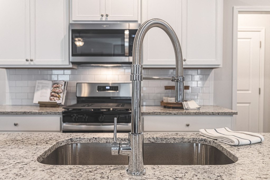 a kitchen with a sink and a faucet in it