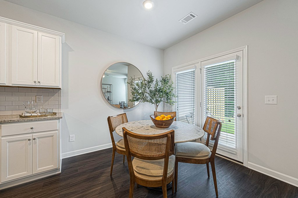a dining room with a table and chairs and a kitchen