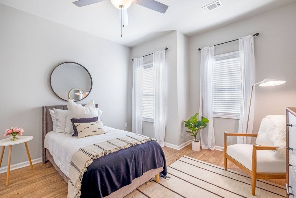 a bedroom with a bed and a ceiling fan