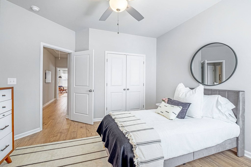 a bedroom with a large bed and a ceiling fan