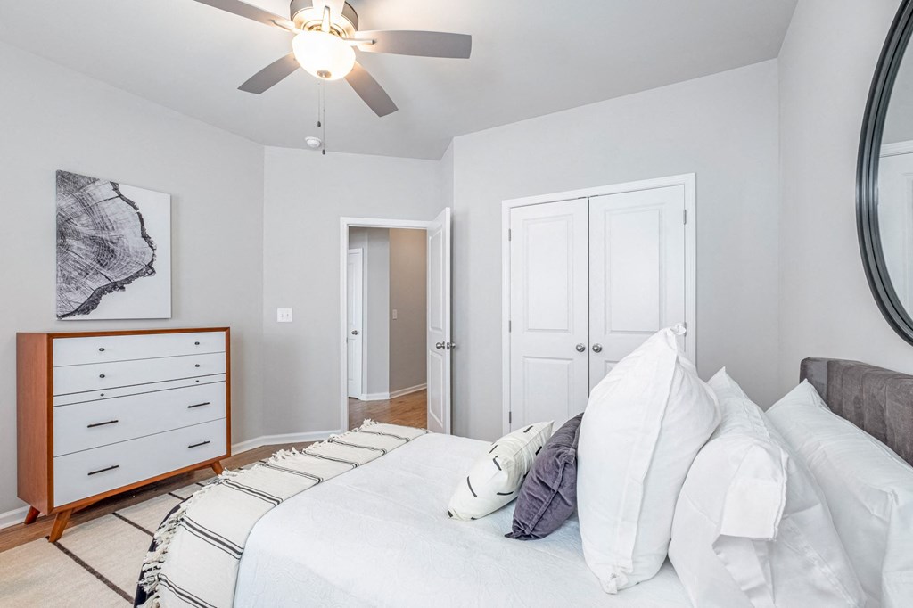 a bedroom with a large bed and a ceiling fan