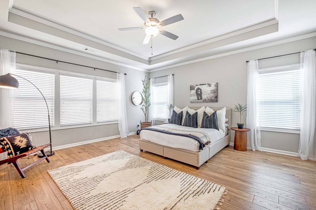 a bedroom with a bed and a ceiling fan
