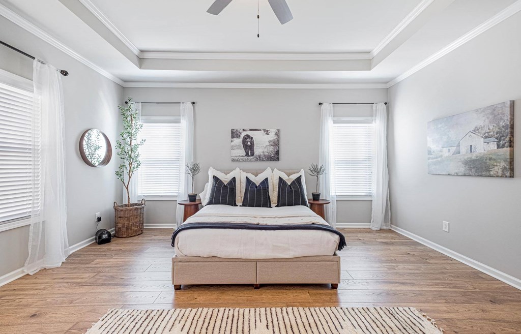 a bedroom with a bed and a ceiling fan