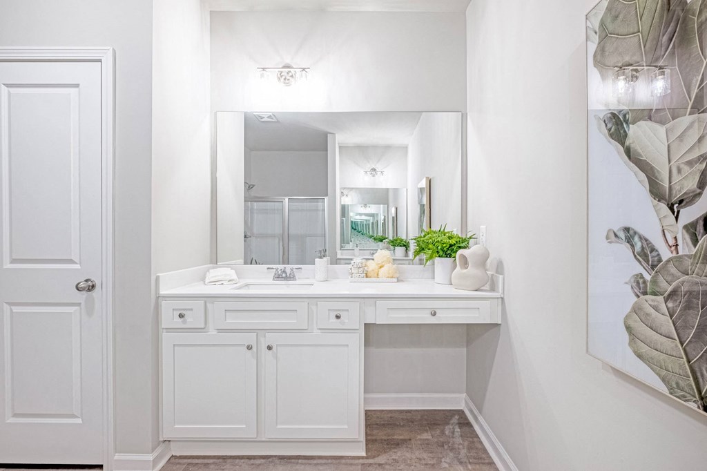 a white bathroom with a sink and a mirror