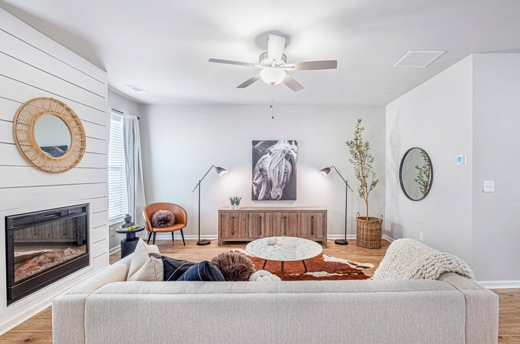 a living room with a couch and a ceiling fan