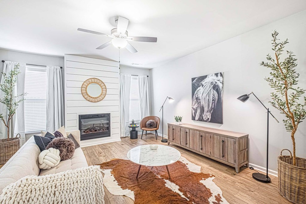 a living room with a couch and a ceiling fan