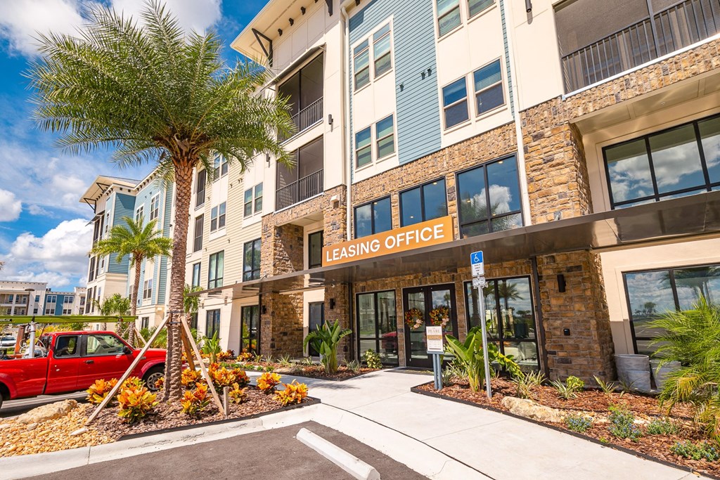 a building with a red car parked in front of it