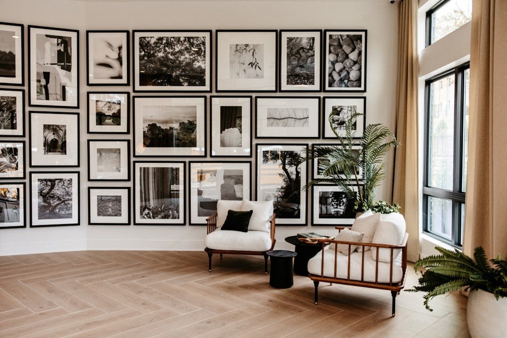 a living room with a bunch of pictures on the wall