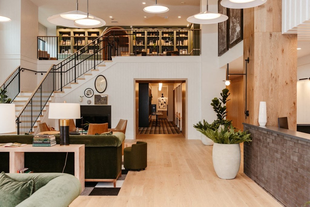 a living room filled with furniture and a staircase