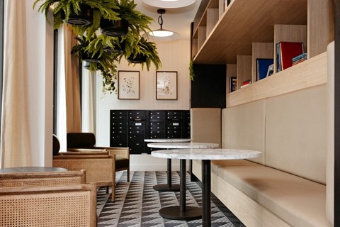 a lobby with a table and chairs and a bench