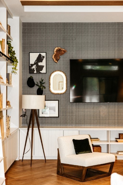a living room with a chair and a television