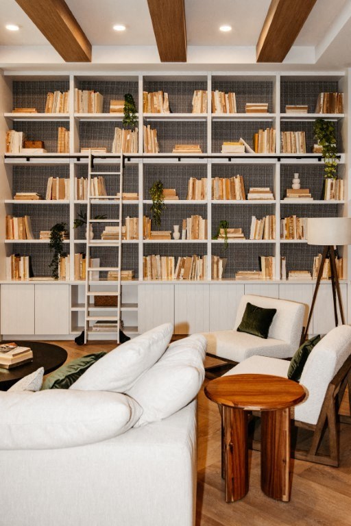 a living room with couches and a book shelf
