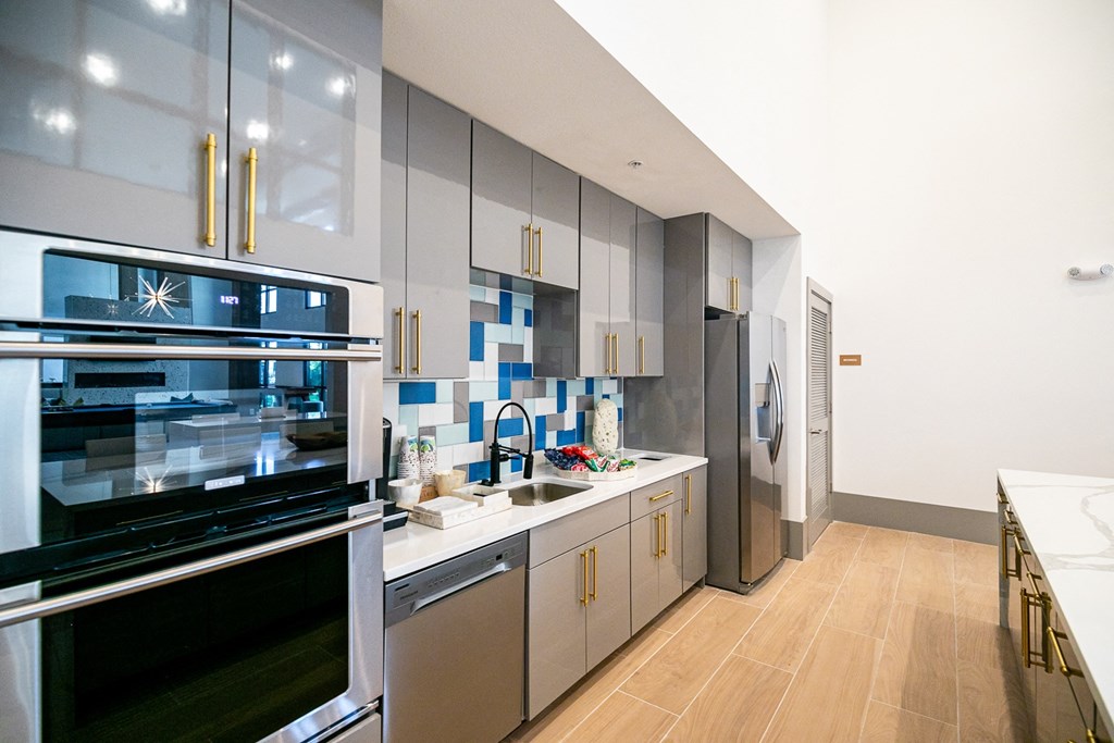 a kitchen with stainless steel appliances and white cabinets