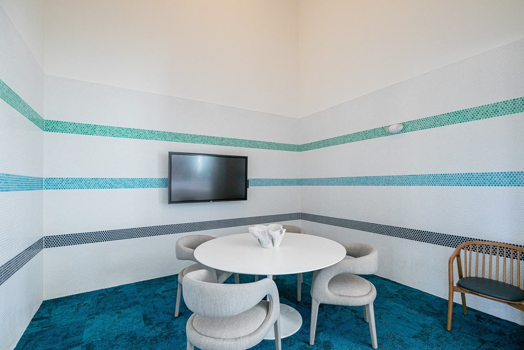 a small room with a table and chairs and a television