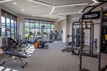 A gym with a variety of equipment including treadmills, weights, and exercise machines at Sterling Nashville West Apartments, Nashville, TN, 37209