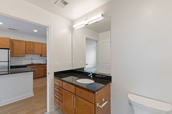 a bathroom with a sink and a mirror in an empty apartment