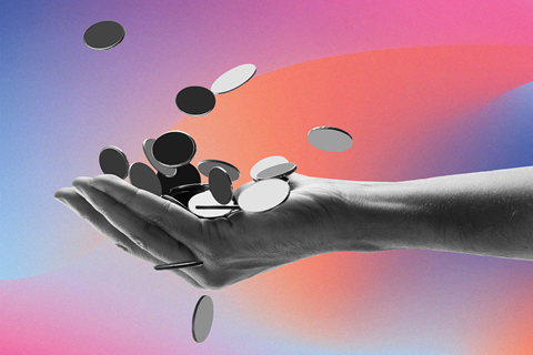 A hand is shown catching falling coins.