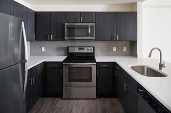 Espresso Cabinetry and White Countertops at The Manhattan Tower and Lofts, 1801 Bassett Street, Denver - Photo Gallery 18