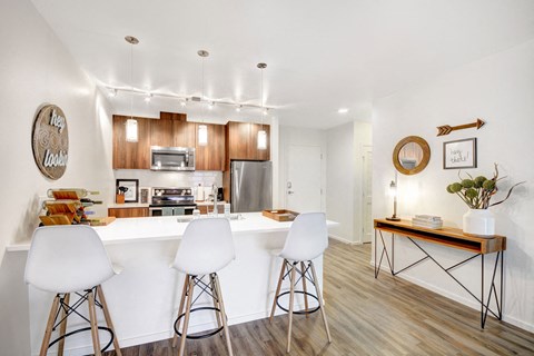 a kitchen with a white counter top and wooden cabinets