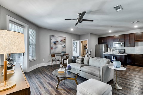 a living room with a couch and a ceiling fan