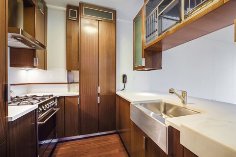 a kitchen with wooden cabinets and a sink