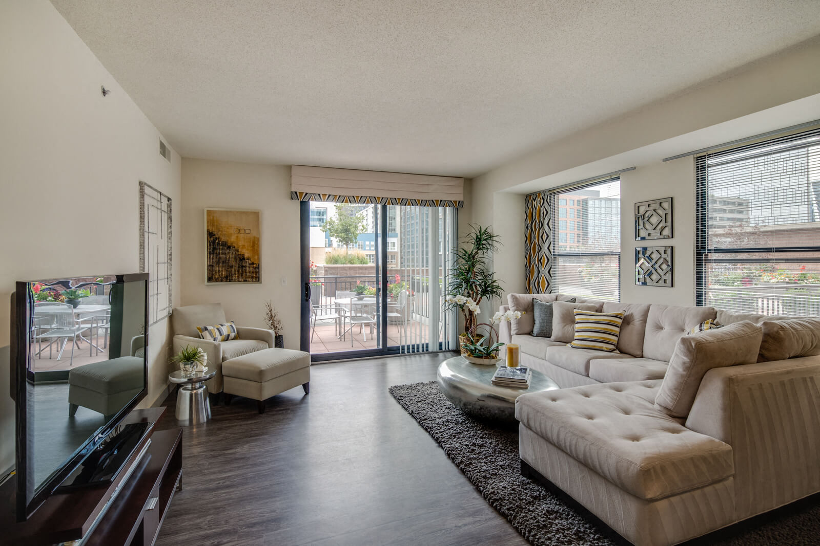 a living room with a couch and a chair and a tv
