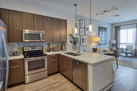a kitchen with stainless steel appliances and a white counter top