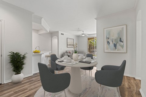 a living room and dining room with a table and chairs