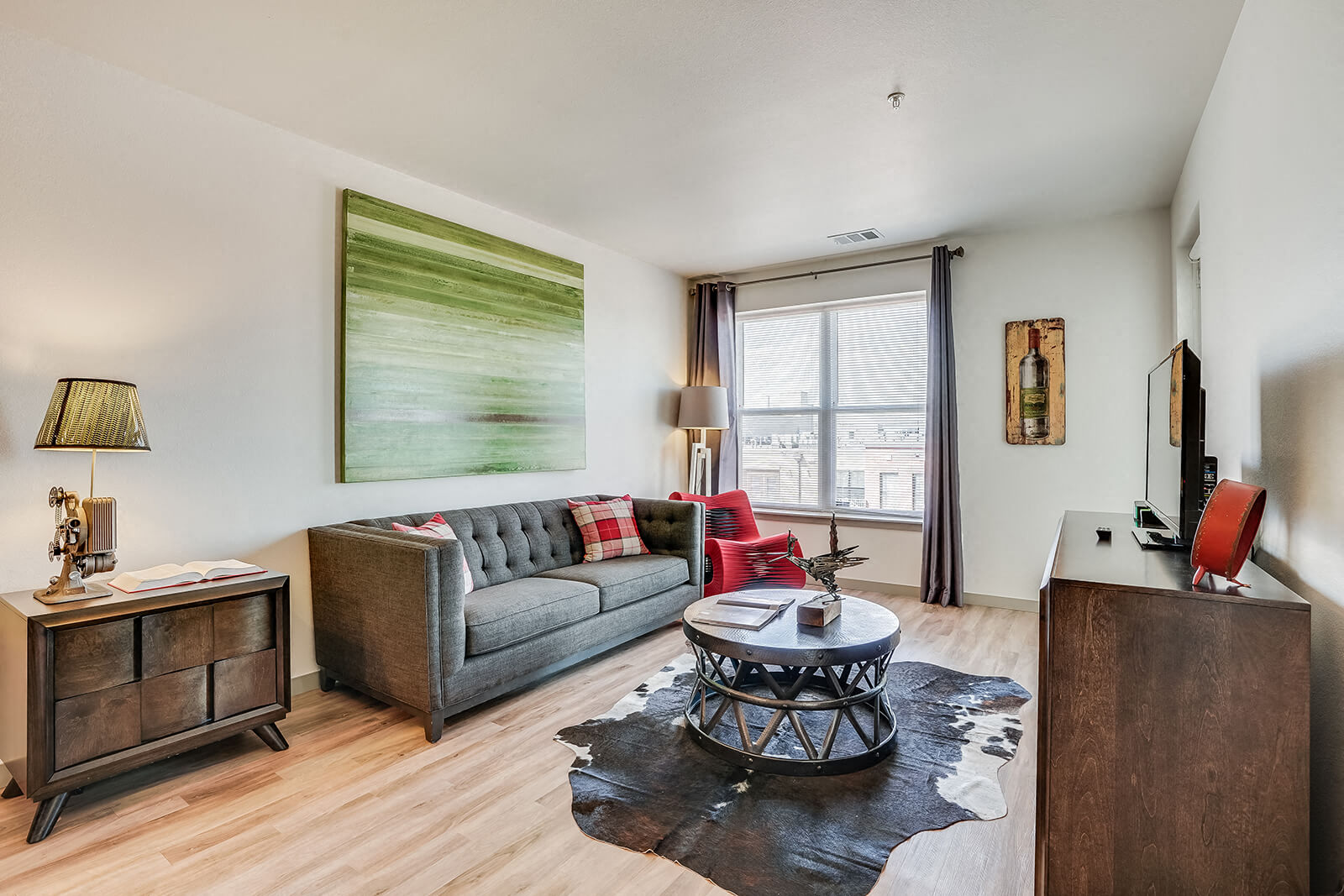 a living room with a couch and a table and a window