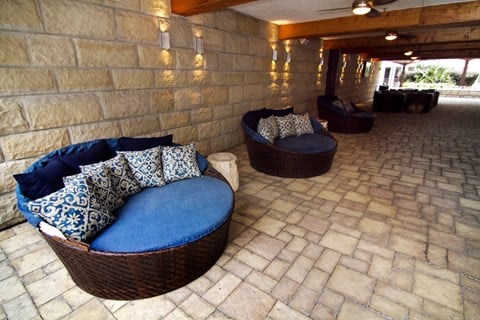 a living room with couches and a stone wall