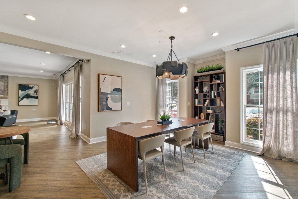 A dining room with a wooden table and chairs.