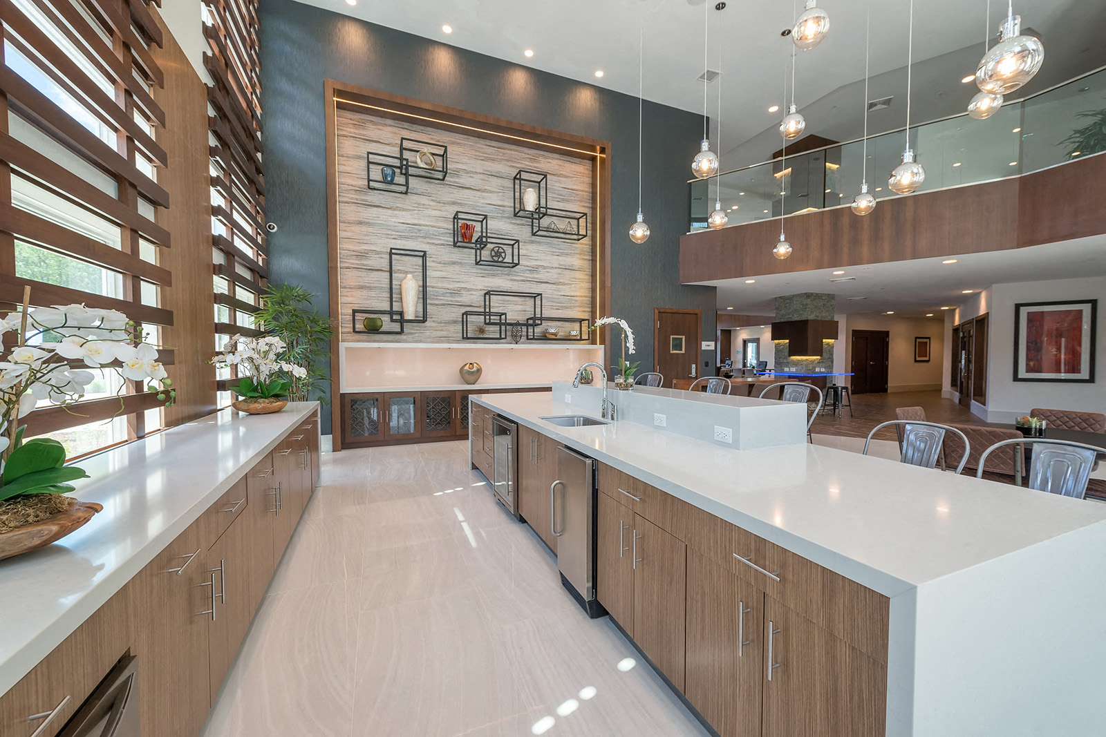 a large kitchen with white counter tops and wooden cabinets