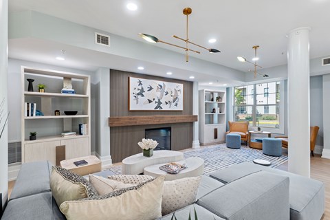 A modern living room with a fireplace and a large painting above it.