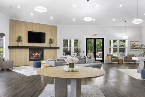 A modern living room with a fireplace and a flat screen TV mounted on the wall.