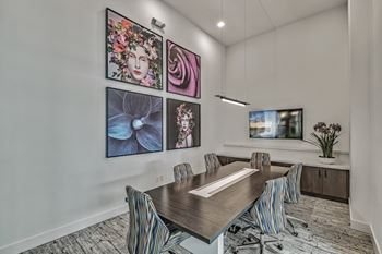 Meeting room with a long table and chairs at Windsor Ludlam Trail, an apartment complex in Miami, FL.