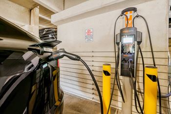 an electric vehicle plugged into a charging station in a garage