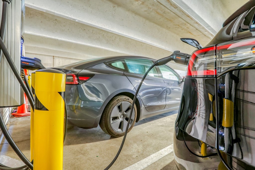 a car is plugged into a charging station in a parking garage