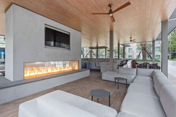 a living room with couches and a fireplace at The Sterling at Regent Square, Houston, TX
