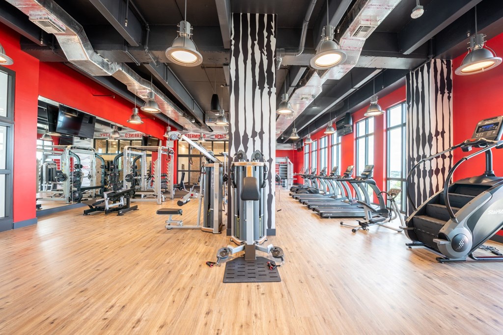 Workout Equipment at Windsor Ludlam Trail in Miami, FL. Fitness Center with hardwood floors and a red wallat Windsor Ludlam Trail in Miami, FL.