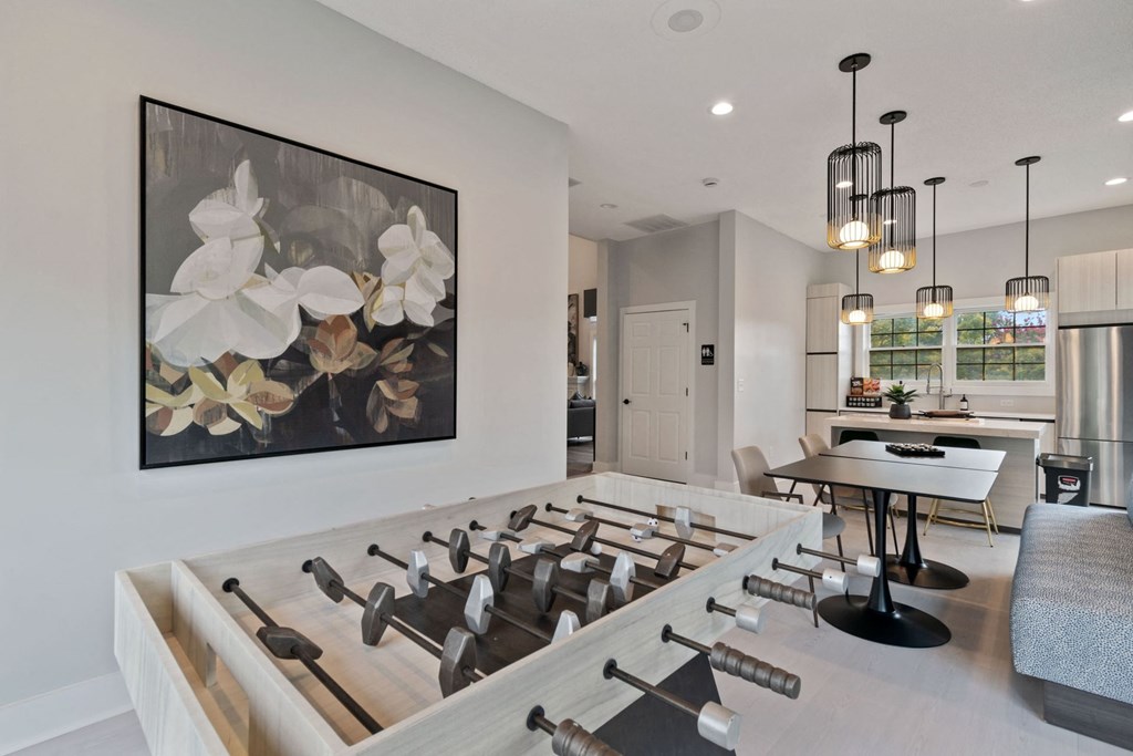 A modern kitchen with a large painting of flowers on the wall.