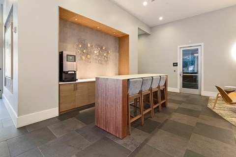 a kitchen with a bar and chairs in a house