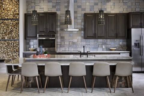a kitchen with a marble counter top and a bunch of chairs