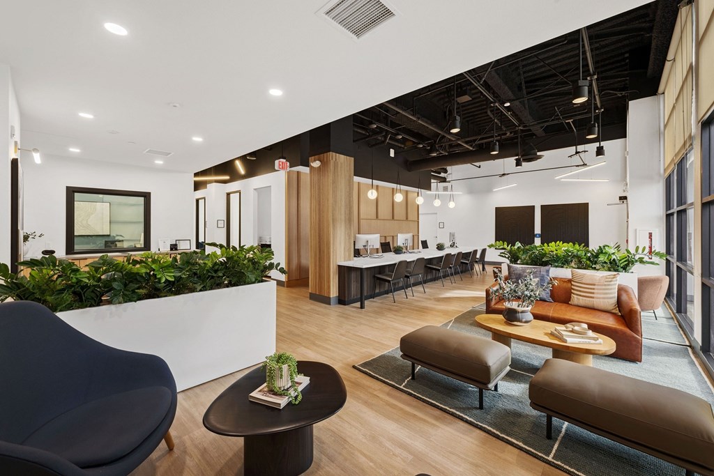 A modern office space with a variety of seating options and plants.