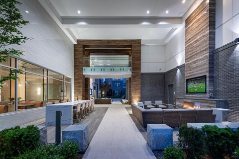 A modern building with a long hallway and a TV on the wall.